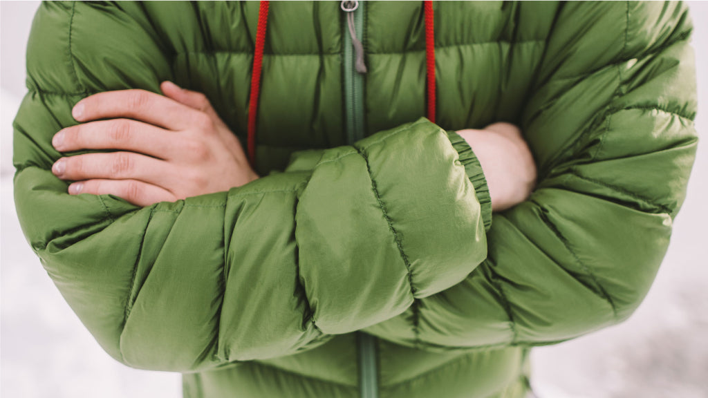 Close up of man in green jacket crossing his arms