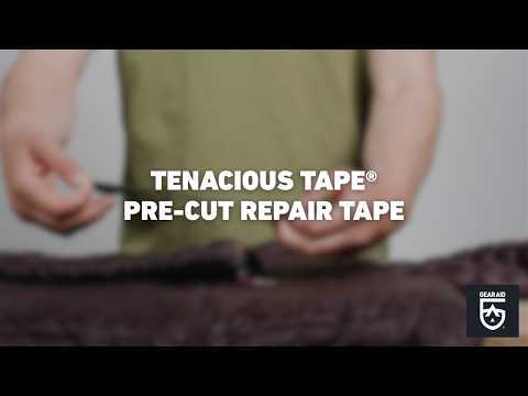 Blurred video cover showing hands holding a pre-cut strip of repair tape above puffy jacket, with the title “TENACIOUS TAPE® PRE-CUT REPAIR TAPE” centered and the Gear Aid logo in the bottom-right corner.