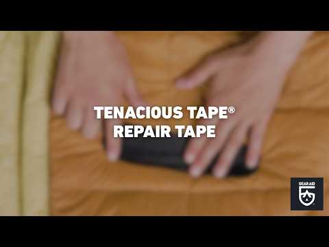 Blurred video cover showing hands smoothing a black repair patch onto an orange sleeping bag, with the title “TENACIOUS TAPE® REPAIR TAPE” centered and the Gear Aid logo in the bottom-right corner.