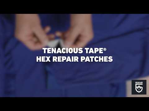 Blurred video cover showing hands applying a hexagon-shaped repair patch to blue outdoor fabric, with the title “TENACIOUS TAPE® HEX REPAIR PATCHES” centered and the Gear Aid logo in the bottom-right corner.