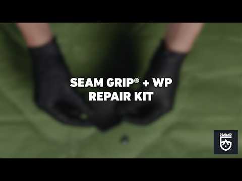 Blurred video cover showing gloved hands repairing green waterproof fabric, with the title “SEAM GRIP® + WP REPAIR KIT” centered and the Gear Aid logo in the bottom-right corner.