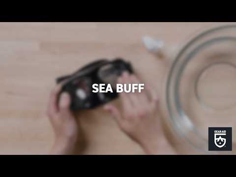Blurred video cover showing hands holding a diving mask on a tabletop, with the title “SEA BUFF” centered and the Gear Aid logo in the bottom-right corner.