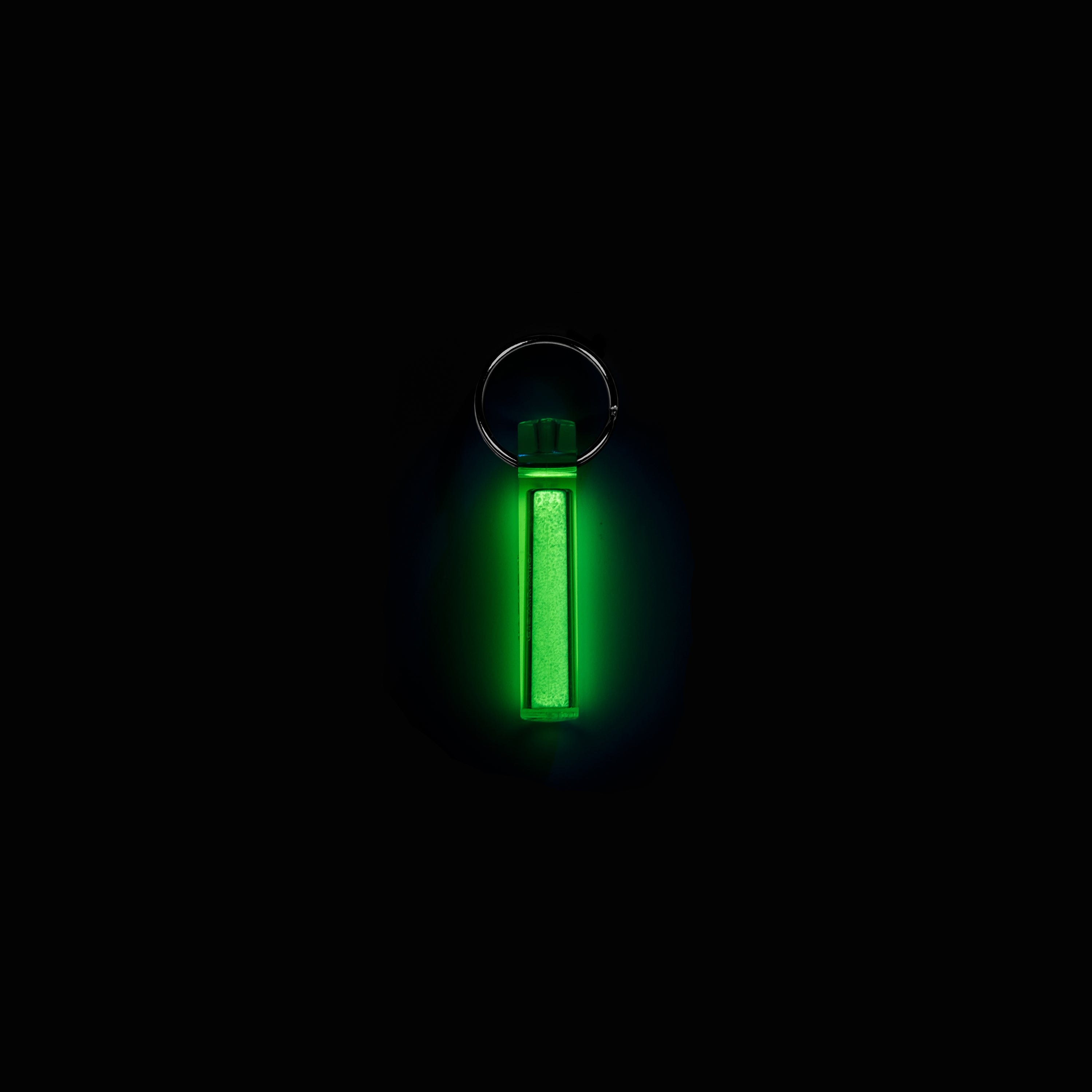 A glowing green Ni Glo gear marker against a black background