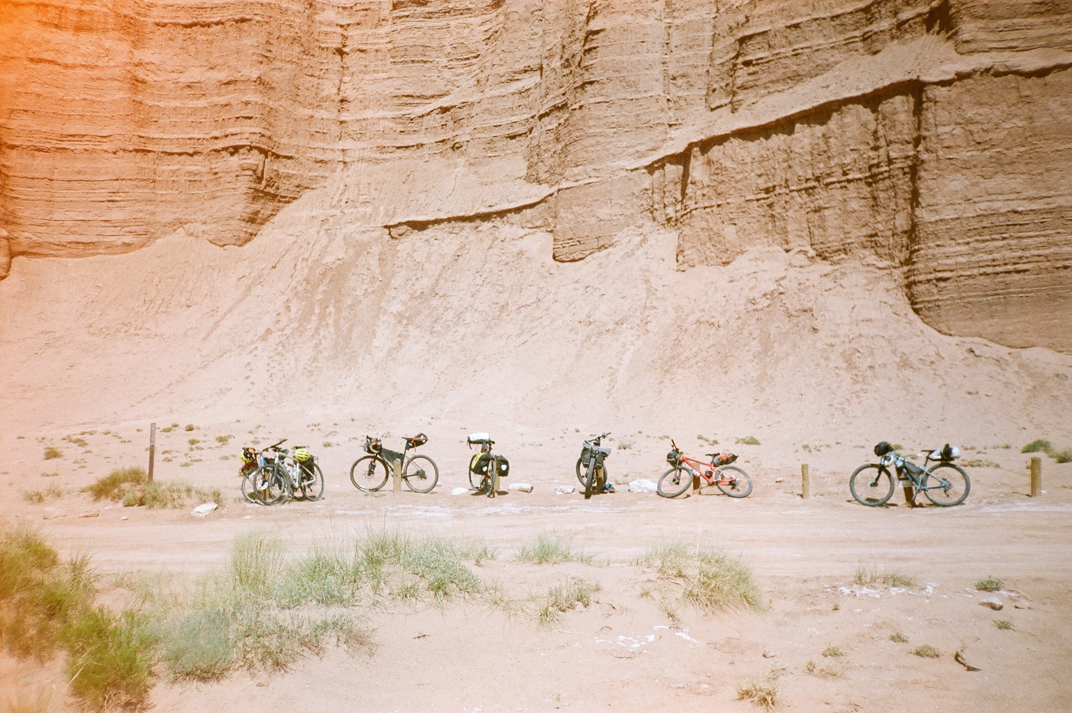 Bikepacking bikes in against a fence in the desert