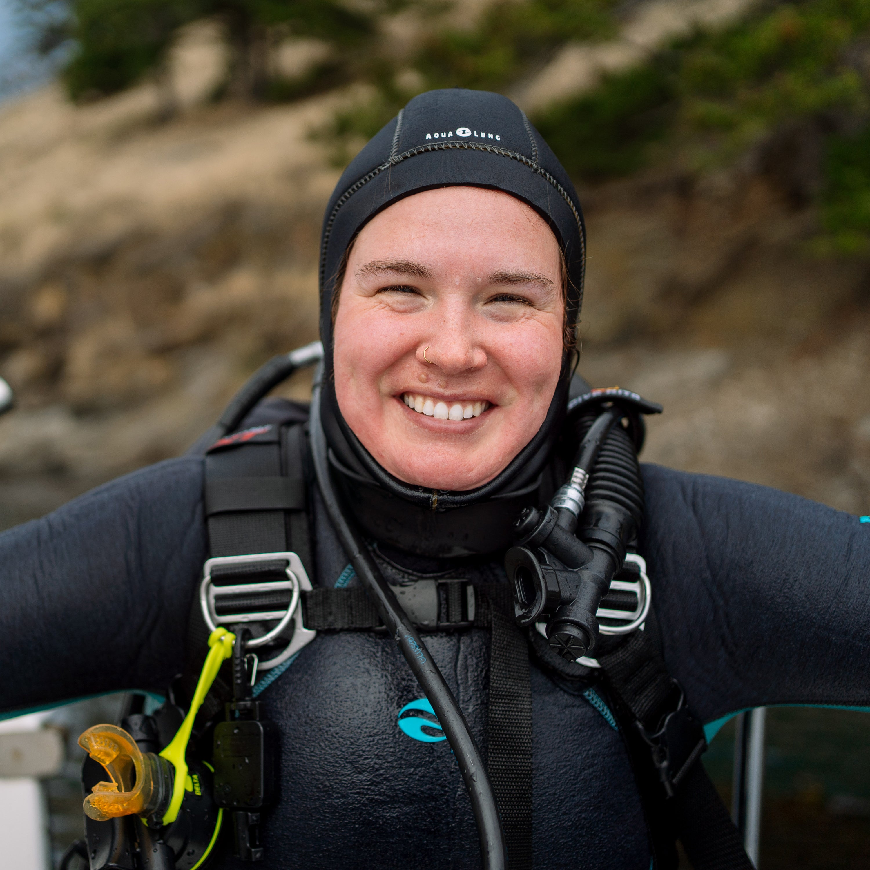 Person wearing scuba diving gear with a scenic background