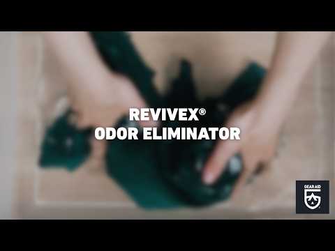 Blurred video cover showing hands handling outdoor clothing in a wash bin or container, with the title “REVIVEX® ODOR ELIMINATOR” centered and the Gear Aid logo in the bottom-right corner.