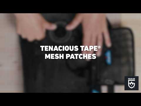 Blurred video cover showing hands repairing black mesh fabric with a patch on a tabletop, with the title “TENACIOUS TAPE® MESH PATCHES” centered and the Gear Aid logo in the bottom-right corner.