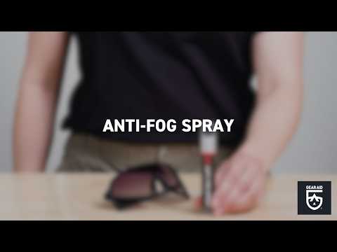 Blurred video cover showing protective eyewear and a small bottle on a tabletop, with the title “ANTI-FOG SPRAY” centered and the Gear Aid logo in the bottom-right corner.